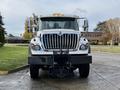 Front view of a 2011 International WorkStar truck featuring a large chrome grille and a snow plow attachment on the front