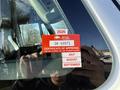 A red certificate of approval sticker displaying the year 2026 and the code GK 69971 attached to the window of a 2017 International 4300 truck