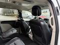 Interior view of a 2017 Dodge Grand Caravan showing two front seats with headrests and a dashboard with controls and display