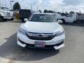 A white 2017 Honda Accord Hybrid with a sleek front design featuring a chrome grille and LED headlights