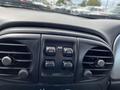 Interior dashboard of a 2005 Chrysler PT Cruiser with air conditioning vents and control buttons for locking and auto functions