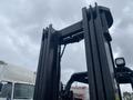 A 2011 Toyota 028FG15 forklift with a vertical mast and attached lifting mechanism visible in the foreground