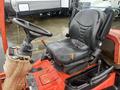 The image shows a black seat and steering wheel of a 2010 Kubota F3680 tractor with a control panel on the left side