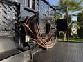 Close-up of a 2017 International 4300 showing tangled electrical wires and connectors mounted on a flatbed truck's surface