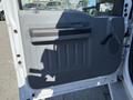 The image shows the interior door panel of a 2011 Ford F-550 featuring a grey plastic design with a door handle and a speaker grille
