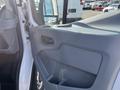 Interior door panel of a 2016 Ford Transit featuring a gray handle and storage compartment