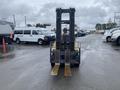A 2010 Hyster S80XLBCS forklift with a black frame and yellow accents featuring two long metal forks at the front