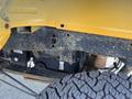 A close-up view of the undercarriage of a 2017 Ford F-250 SD showing the chassis components and a rugged tire tread