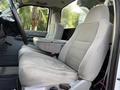 Interior view of a 2006 Ford F-550 showing two gray cloth seats and a center console without any passengers