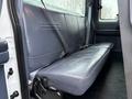 A folded back seat of a 2001 Ford F-350 with a dark blue upholstery and seatbelt visible