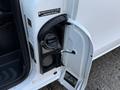 Close-up of the fuel door on a 2020 Mercedes-Benz Metris showing the fuel cap and attached cable