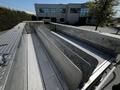A metal drainage area on top of a fire truck with multiple channels for water runoff and a textured surface