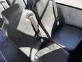 The image shows a row of black leather seats with seat belts in a 2022 Blue Bird Vision bus
