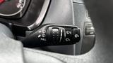 A close-up view of the control stalk in a 2012 Ford Transit featuring symbols for windshield wipers and headlights