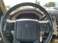 Steering wheel of a 2014 Ford F-350 SD with the Ford logo and control buttons visible