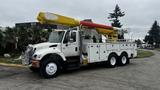 A 2006 International 7500 truck with a yellow and orange aerial boom lift mounted on the bed and multiple storage compartments along the side