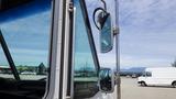 A 2011 Ford Econoline seen from the driver's side with a focus on the door and side mirror