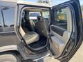 Interior view of a 2003 Hummer H2 showing the backseat area with leather seats and a console