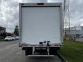 A 2019 Hino 195 box truck parked with a plain white rear surface and a hitch connecting to the back of the vehicle