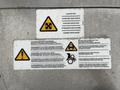 A 2018 Isuzu NRR featuring several warning and instructional labels regarding fan operation and safety procedures