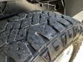 Close-up of a worn tire tread from a 2022 RAM 3500 showcasing deep grooves and rough texture essential for traction and performance