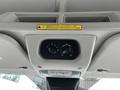 Ceiling console of a 2017 Ford Transit 350 with control knobs for climate settings and a warning label above