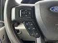Close-up of the steering wheel controls of a 2020 Ford F-350 with buttons for setting cruise control and adjusting settings