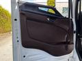 Interior door panel of a 2021 Hino 338 featuring a brown handle and trim with a textured design