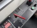 Close-up of a door controller panel from a 2018 Grande West Vicinity featuring a red lever green button and various switches for controlling doors and starting the engine