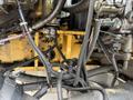 A close-up view of the machinery components of a 2018 John Deere 350 showing tangled wiring harnesses and connectors