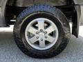 A close-up of a 2017 Mercedes-Benz Sprinter wheel featuring a silver alloy rim and a rugged tire with a deep tread pattern