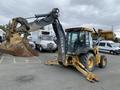 A 2012 John Deere 310SJ backhoe loader with a yellow and black color scheme featuring a front loader bucket and a rear digging arm