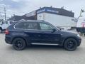 A 2009 BMW X5 SUV in black with a side profile view showcasing tinted windows and black alloy wheels