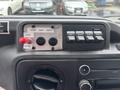 Control panel of a 2014 Ford E-350 featuring buttons for door and heater controls along with auxiliary switches