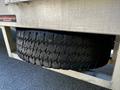 A 2008 Ford F-550 truck tire mounted underneath the vehicle