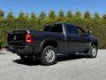 A black 2022 RAM 3500 truck with a crew cab and four-wheel drive features chrome accents and large alloy wheels