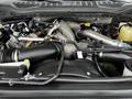 The image shows the engine compartment of a 2020 Ford F-350 with various components including pipes and hoses arranged around a large engine block