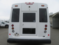 A white 2020 Chevrolet Express van viewed from the rear with a large window and wheelchair accessibility symbol