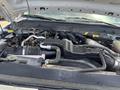 Engine compartment of a 2015 Ford F-550 featuring various hoses wires and components arranged around the engine block