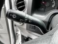 A close-up of the control stalk in a 2013 Ford Econoline with symbols for windshield wipers and headlights
