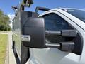 A 2023 Ford F-550 pickup truck with a prominent side mirror visible in the foreground