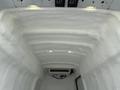 Interior of a 2017 Ford Transit cargo van with a white textured surface and ceiling lights