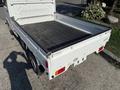 White 2008 Suzuki Carry pickup truck with an open flatbed and a black lining in the cargo area