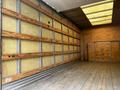 A 2021 Ford E-450 box truck with an empty interior featuring wooden paneling and a wooden floor without any visible cargo