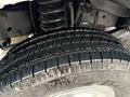 Close-up of a rugged tire with deep tread on a 2013 Ford Econoline showing details of the rubber and wheel rim
