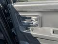The interior door handle and controls of a 2011 RAM 1500 including a chrome handle and window switch