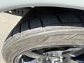Close-up view of a tire and wheel from a 1962 Ford F-100 showing a sleek design and tread pattern with shiny chrome accents