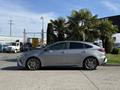 A silver 2024 Kia Forte5 parked with sleek lines and sporty wheels, showcasing its modern design and profile