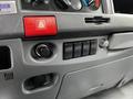 Dashboard controls and switches of a 2018 Isuzu NPR including a hazard light button and power outlets