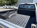 A 2016 Ford F-150 with an empty cargo bed showing a textured black liner and side walls